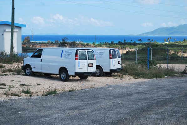 Mr. Electric service vans parked along the Anguilla coastline